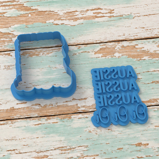 Aussie Aussie Aussie Oi Oi Oi Plaque cookie cutter and matching embosser on coastal timber.