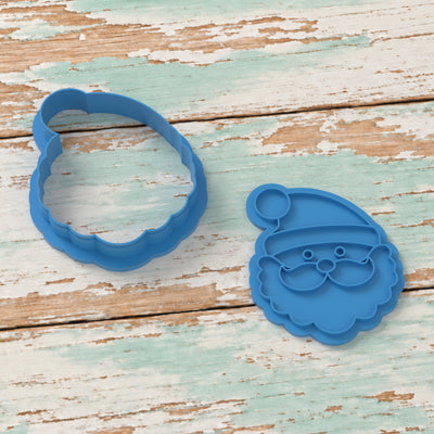 Cute Santa Claus Face cookie cutter and matching embosser on coastal timber.