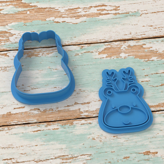 Cute Reindeer Face cookie cutter and matching embosser on coastal timber.