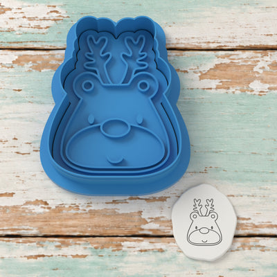 Cute Reindeer Face cutter and embosser with a rendered fondant impression example.