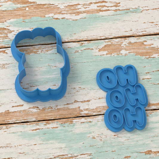 Ho Ho Ho cookie cutter and matching embosser on coastal timber.