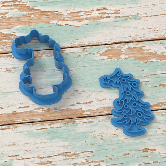 Whimsical Christmas Tree cookie cutter and matching embosser on coastal timber.