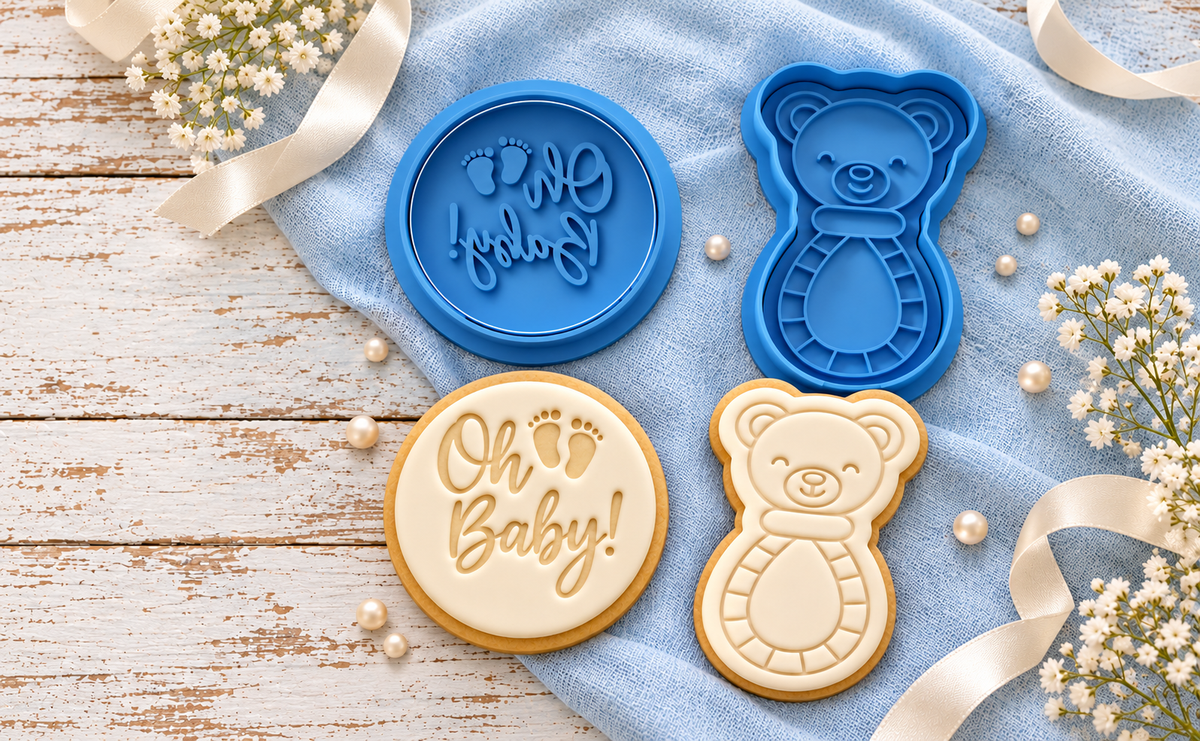 Blue cookie cutters and matching fondant cookies in a baby shower scene
