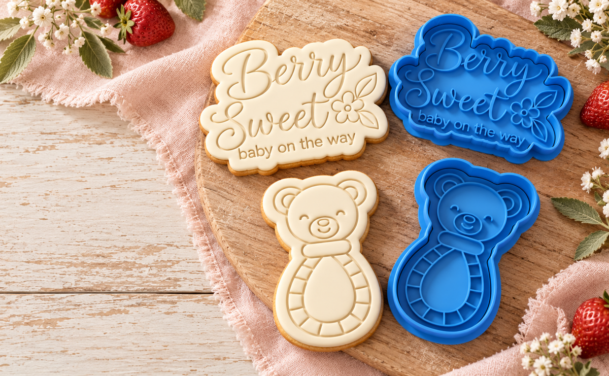Blue cookie cutters and matching fondant cookies in a berry baby scene
